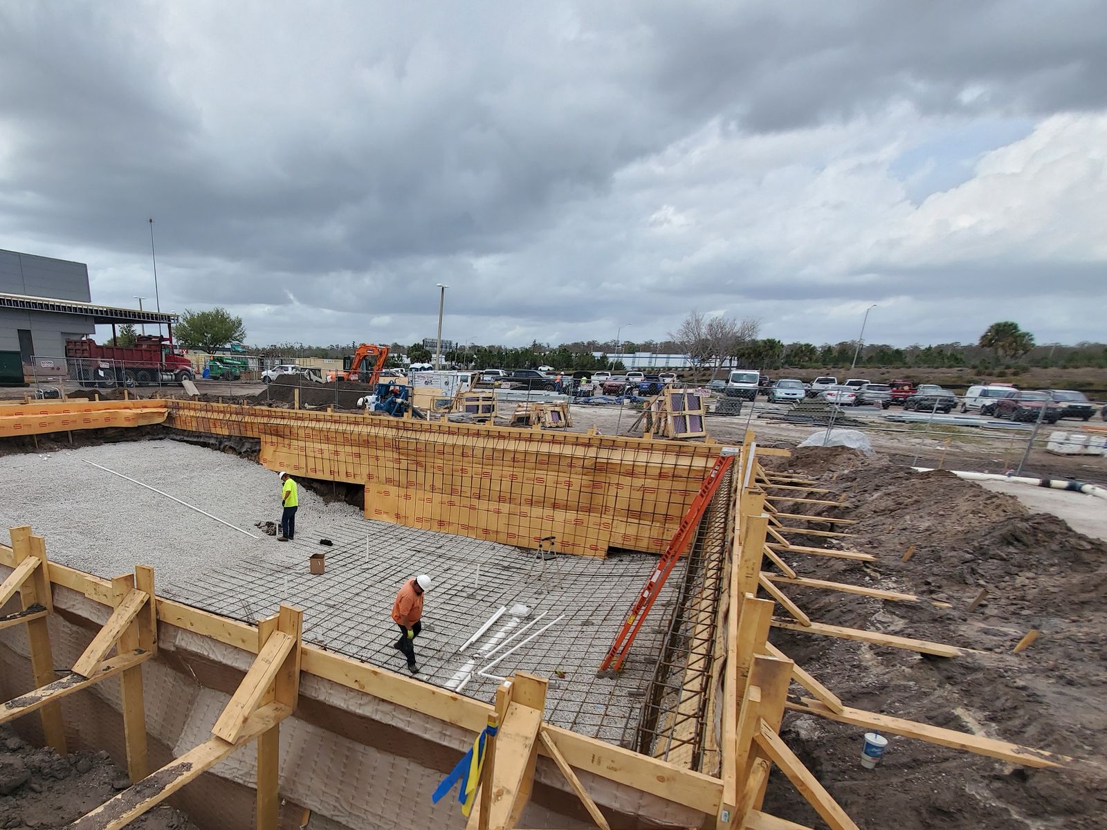 Commercial pool shell under construction, with wood forms and steel reinforcing