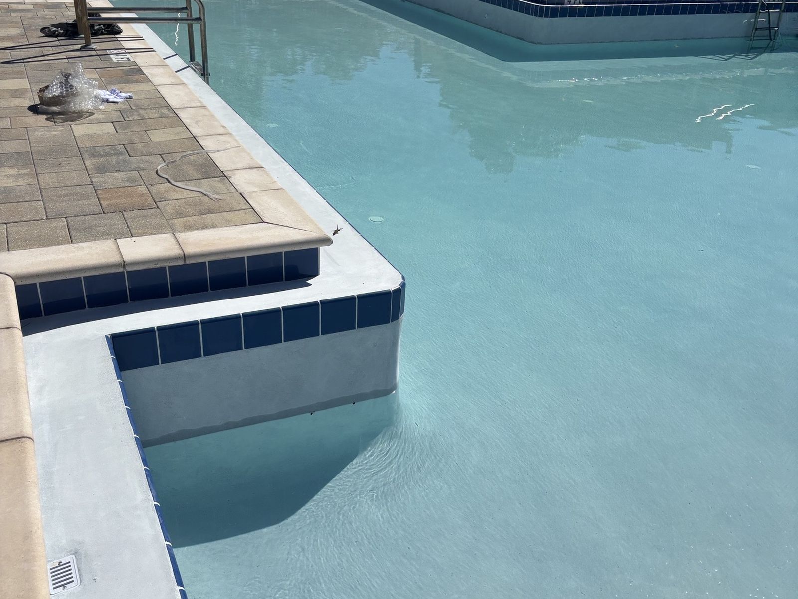 Refilled community pool with a new finish and blue waterline tile