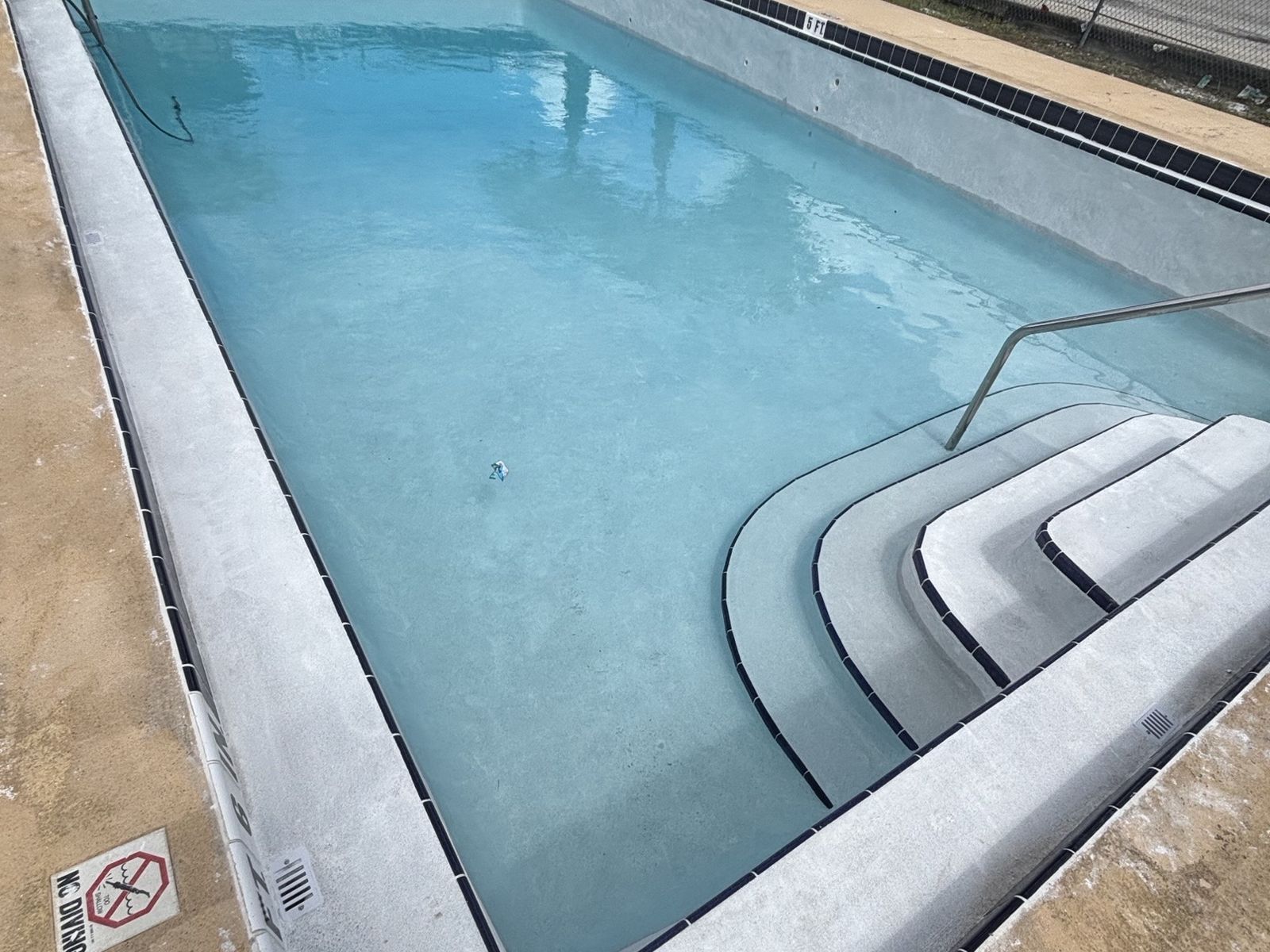 Resurfaced commercial pool with new finish on the entry steps